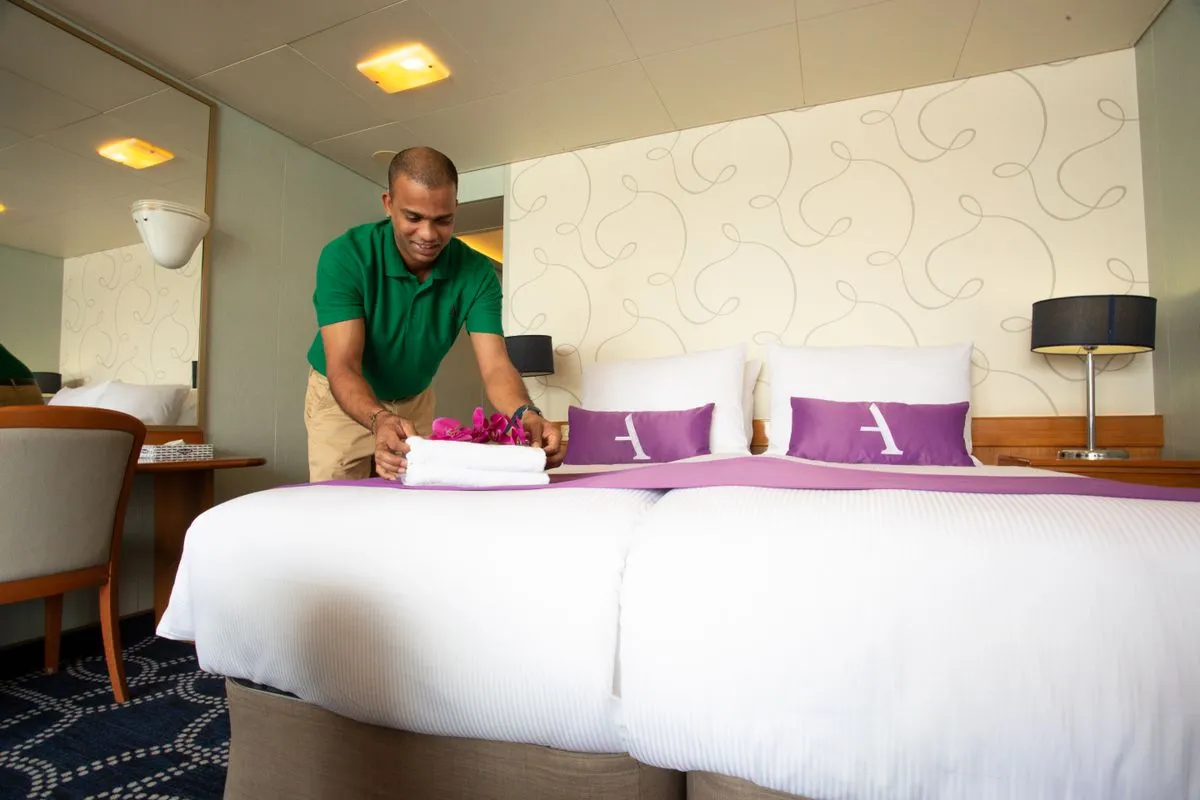 Man putting towel on a bed