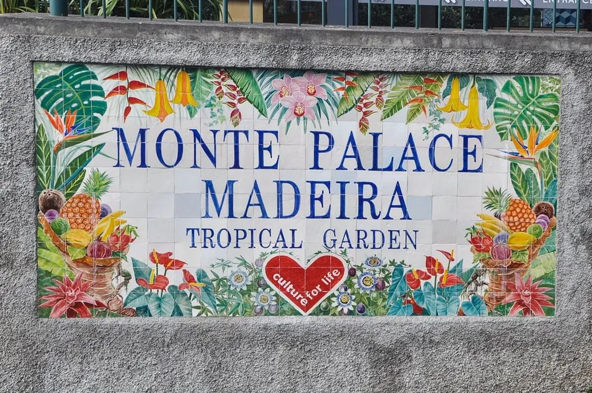 Colourful tiled sign for Monte Palace Madeira Tropical Garden, featuring tropical plants, fruits, and birds with a "Culture for Life" emblem.
