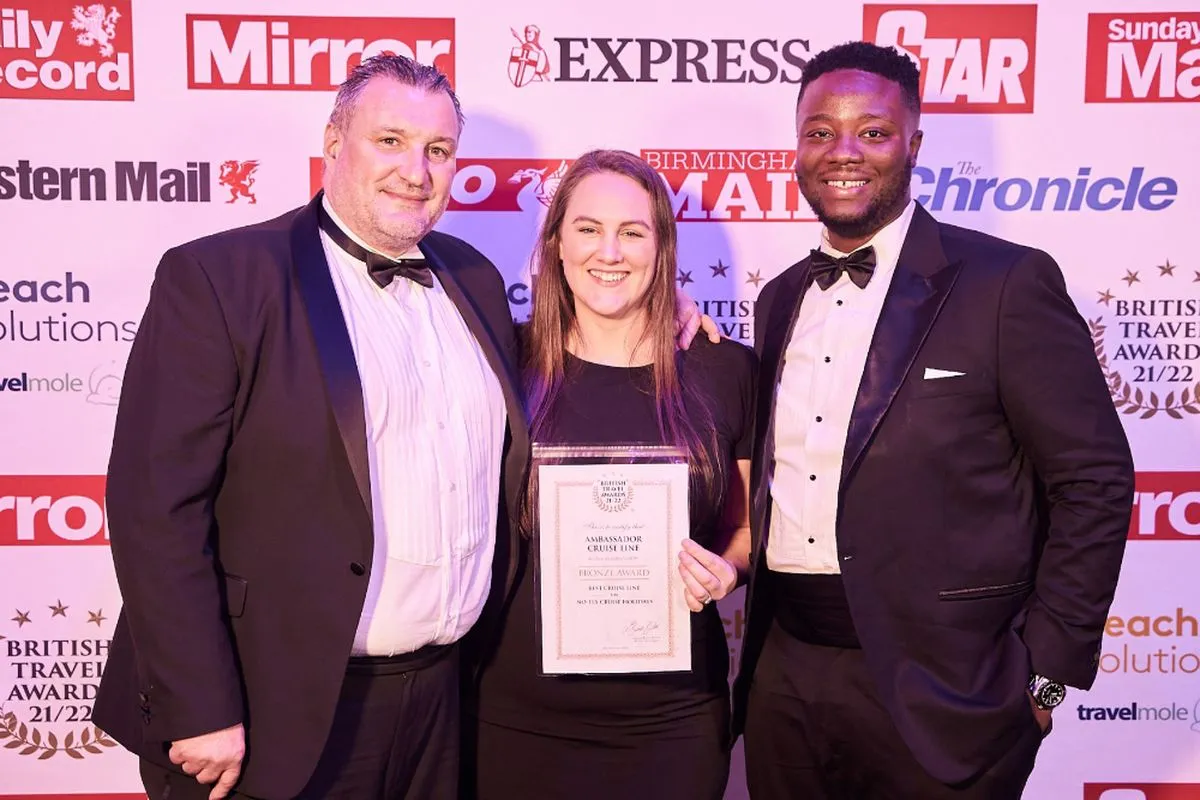 Gordon and Delasi collecting the award for Ambassador Cruise Line