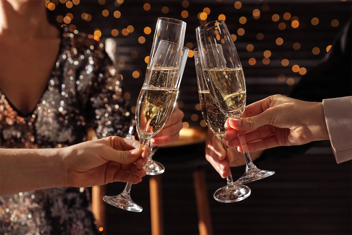 People clinking champagne glasses at Christmas