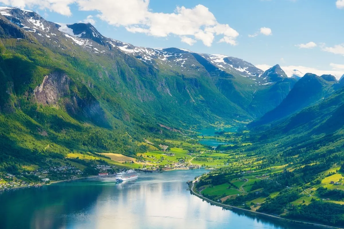 Cruise ship sailing along the fjord in summer