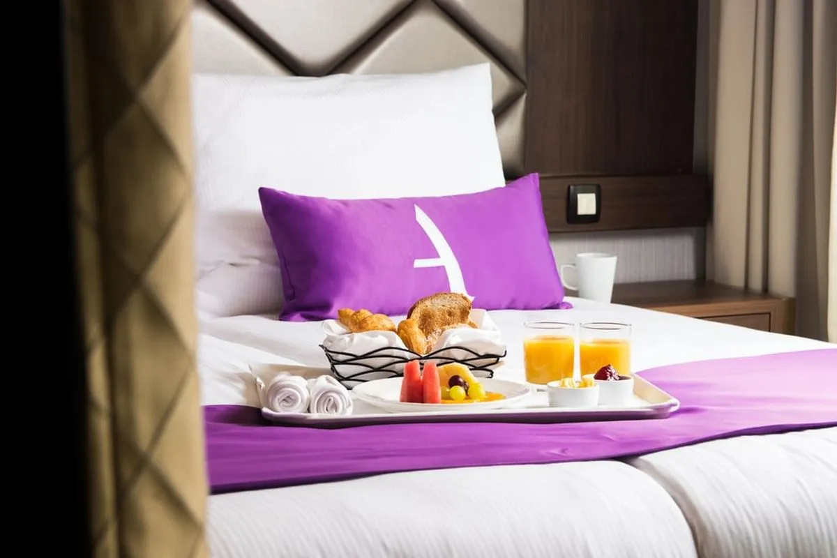 Breakfast tray on bed in the cozy suite