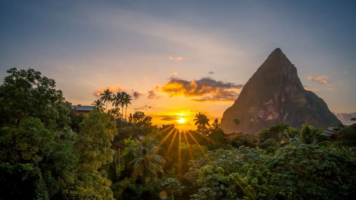 Sunset over lush tropical forest with a prominent mountain peak in Castries St Lucia