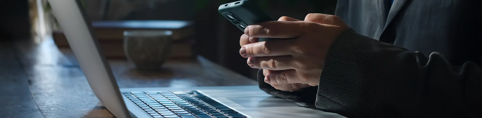Person connecting to WIFI on the smartphone while sitting at her desk