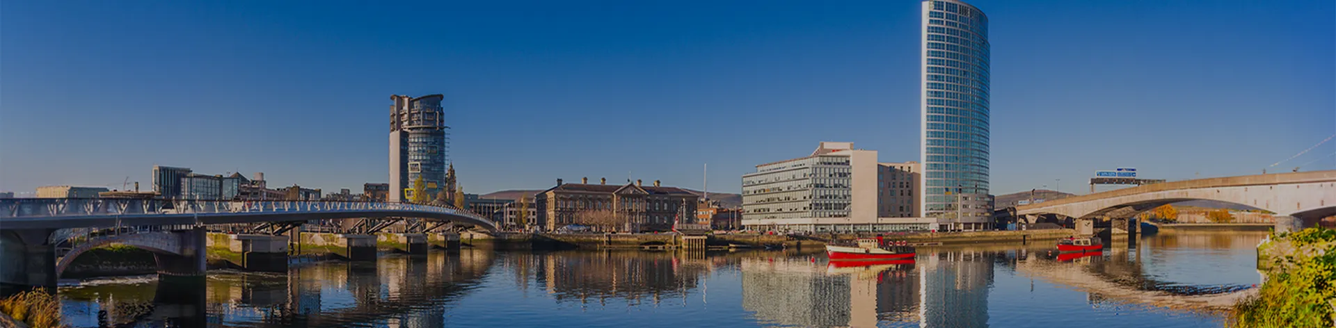 Panoramic view of Belfast with modern buildings beside a river