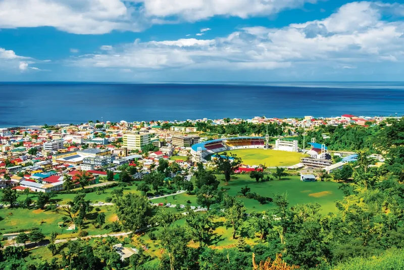 Bright and colourful aerial view of coastline and buildings of Roseau, Dominica.