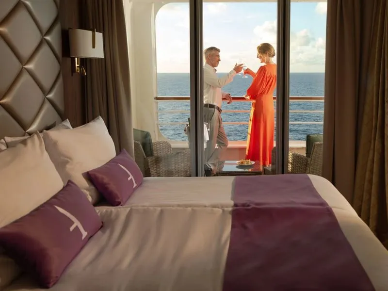 Couple toasting on the suite balcony