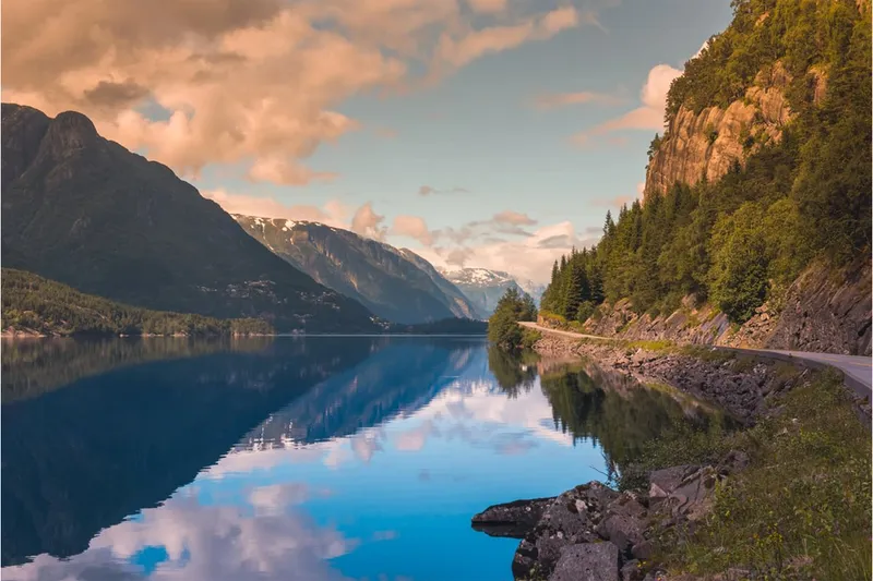A serene lake reflecting mountains in hardangerfjord