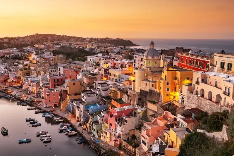 Procida, Italy old town skyline in the Mediterranean Sea during dusk