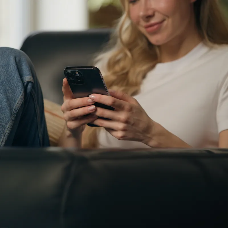 Woman user holding mobile phone and connecting to WiFi