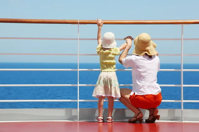 Mother and child looking out to sea from a cruise ship.