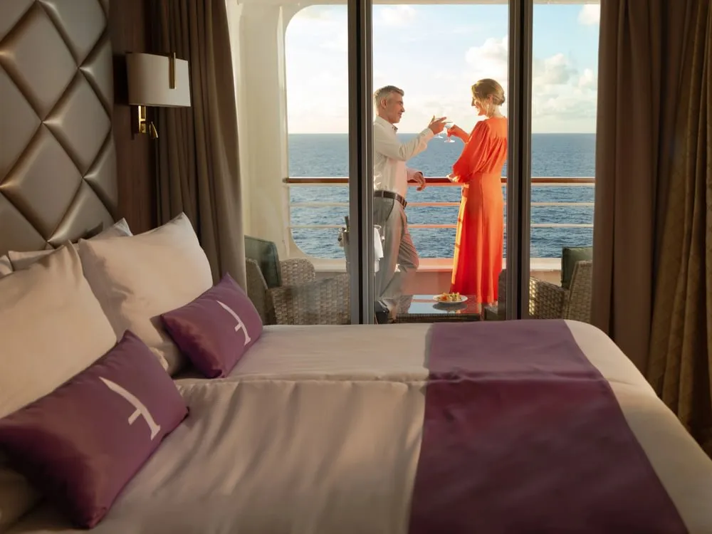 Couple toasting on the suite balcony
