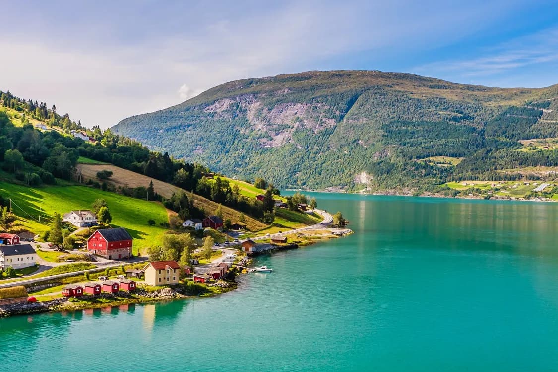 Red houses on the shoreline in Olden, Norway
