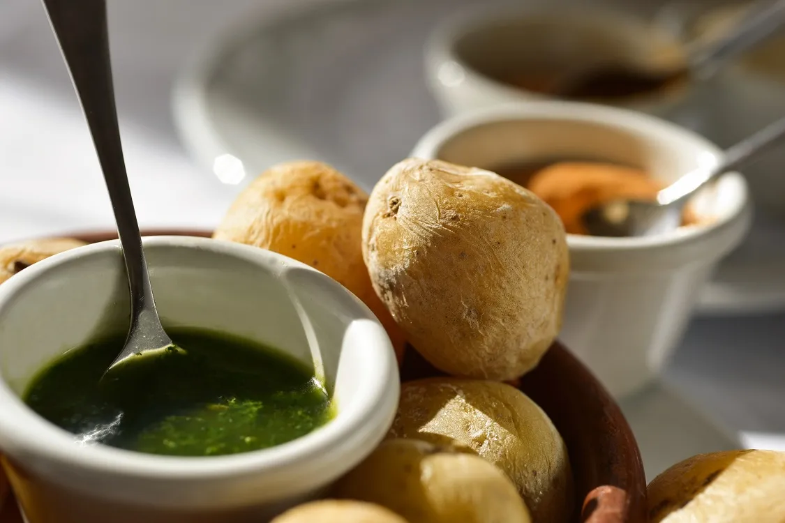 A plate of papas arrugadas served with mojo verde and mojo rojo