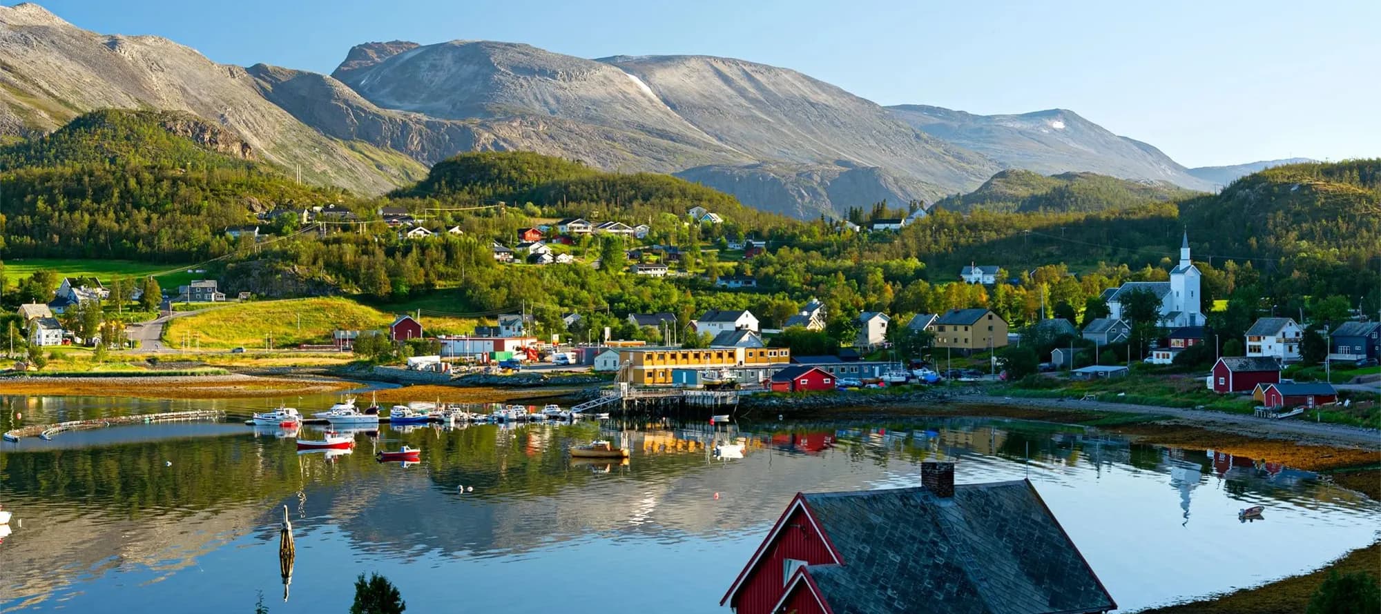 Characteristic small norwegian town near a fiord. Near Alta, Norway.
