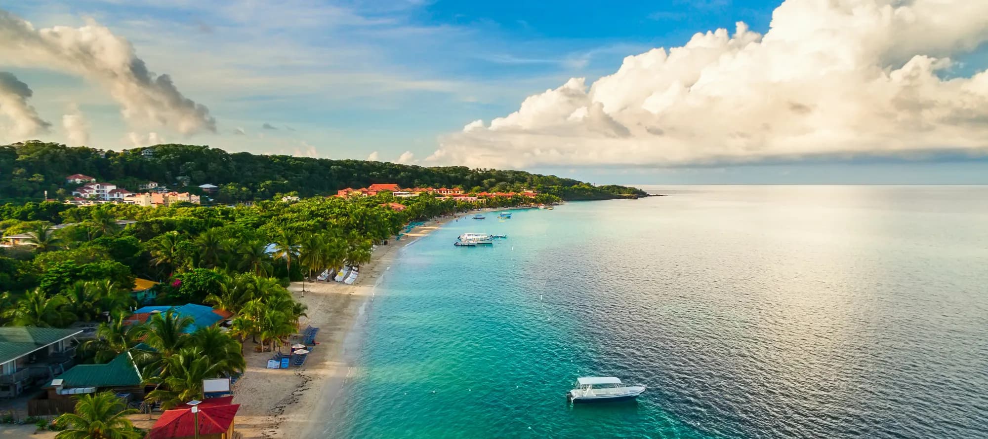 An aerial view of a tropical beach in Roatán Honduras early in the morning.