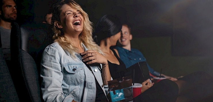 Woman laughing in a cinema